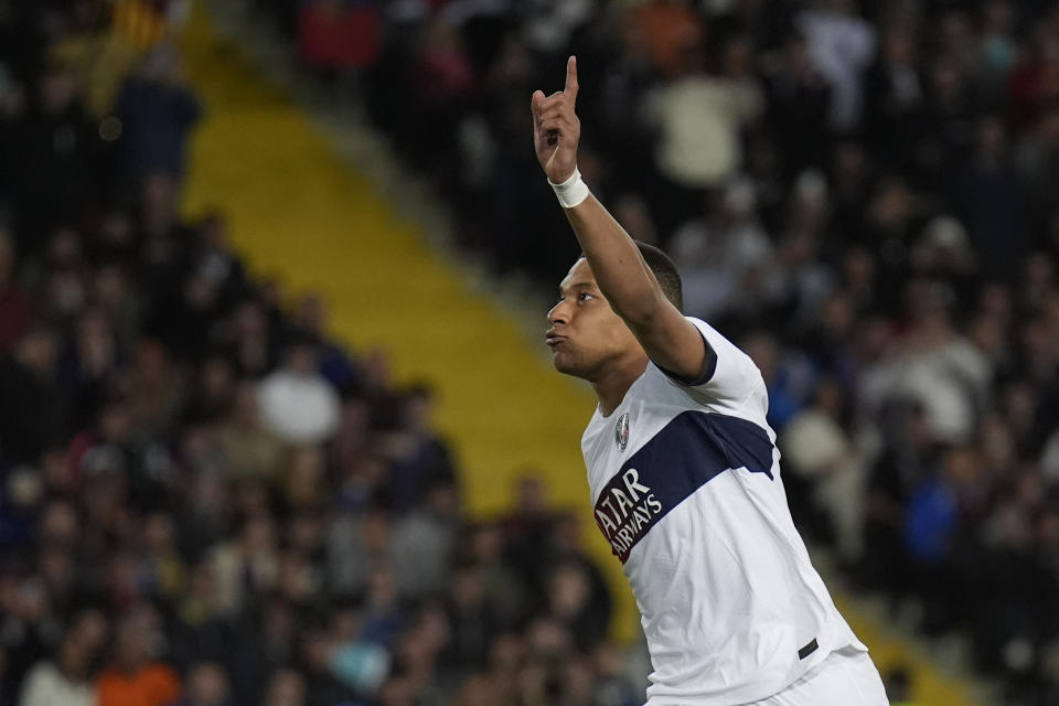 PSG's Kylian Mbappe celebrates after scoring his side's third goal during the Champions League quarterfinal second leg soccer match between Barcelona and Paris Saint-Germain at the Olimpic Lluis Companys stadium in Barcelona, Spain, Tuesday, April 16, 2024. (AP Photo/Emilio Morenatti)