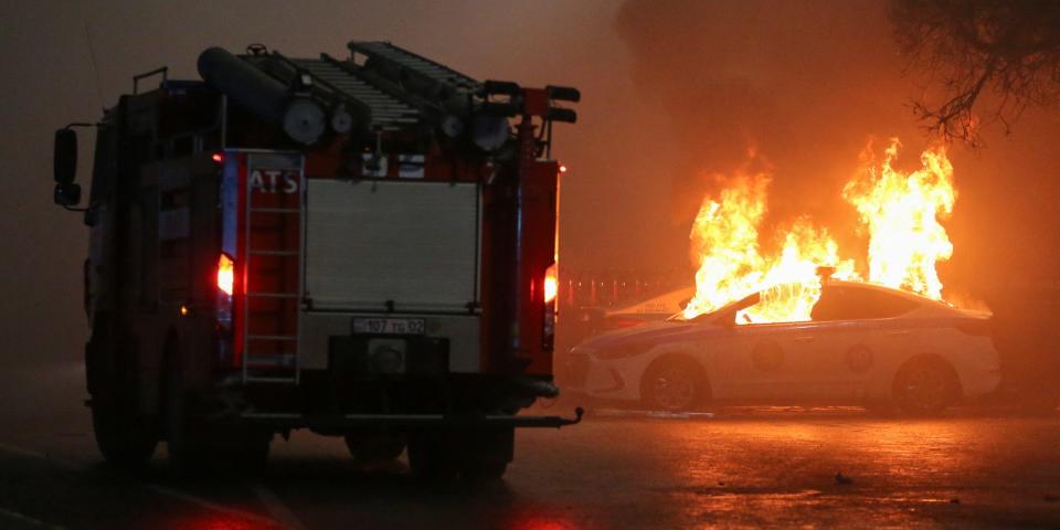 A view shows a burning police car during a protest against LPG cost rise following the Kazakh authorities' decision to lift price caps on liquefied petroleum gas in Almaty, Kazakhstan January 5, 2022. REUTERS/Pavel Mikheyev