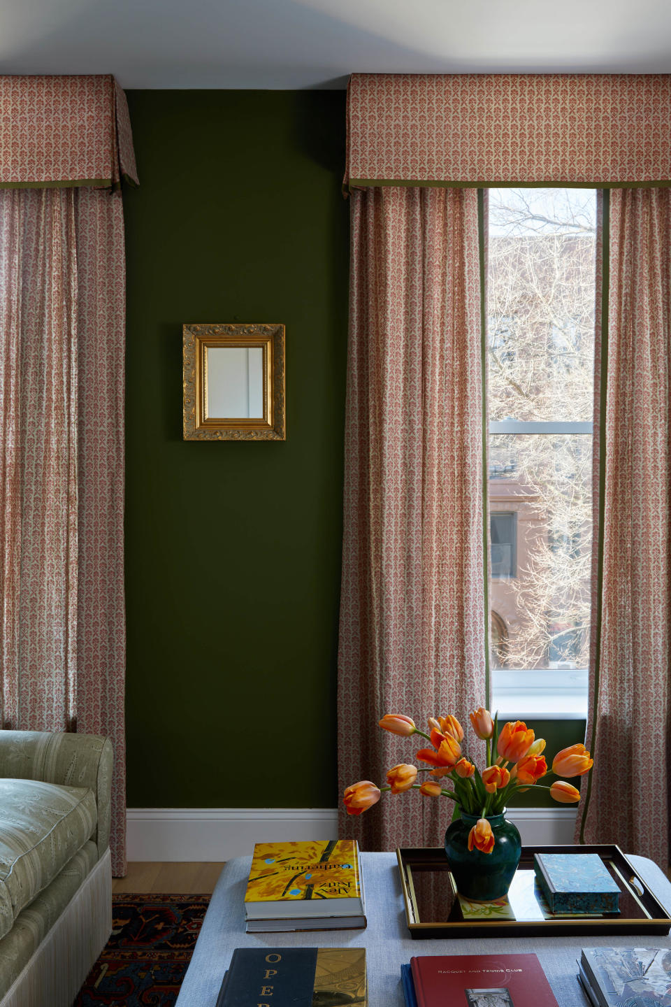 A living room with tulips in a vase