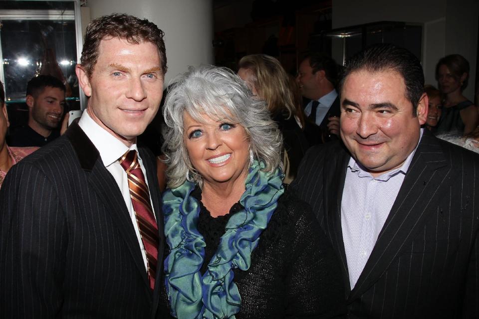 FILE - In this Nov. 16, 2010 file photo provided by StarPix, from left to right, celebrity chefs Bobby Flay, Paula Deen, and Emeril Lagasse from the Food Network attend the unveiling of Barneys New York food themed holiday windows in New York. It was revealed that Deen admitted during questioning in a lawsuit that she had slurred blacks in the past. It's the second time the queen of comfort food's mouth has gotten her into big trouble. She revealed in 2012 that for three years she hid her Type 2 diabetes while continuing to cook the calorie-laden food that's bad for people like her. The Food Network, which began airing "Paula's Home Cooking" in 2002, has said it does not tolerate discrimination and is looking at the situation. (AP Photo/Marion Curtis, StarPix, file)