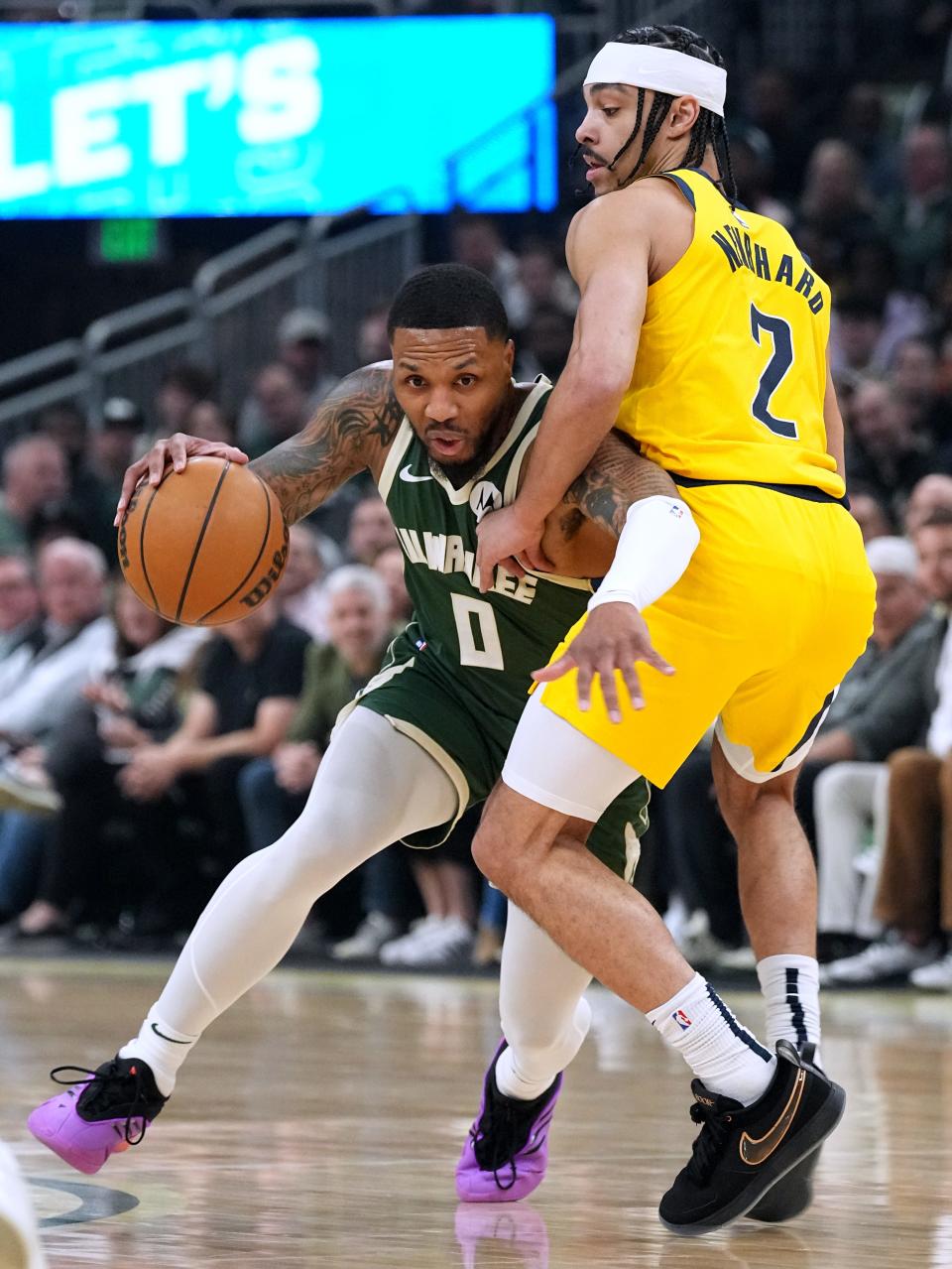 Milwaukee Bucks guard Damian Lillard  drives on Indiana Pacers guard Andrew Nembhard during the first half of their first-round playoff game Sunday at Fiserv Forum. Lillard scored a Bucks first-half playoff record 35 points.