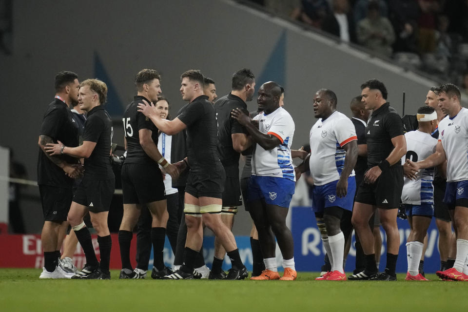 Players shake hands after the Rugby World Cup Pool A match between New Zealand and Namibia at the Stadium de Toulouse in Toulouse, France, Friday, Sept. 15, 2023. (AP Photo/Christophe Ena)