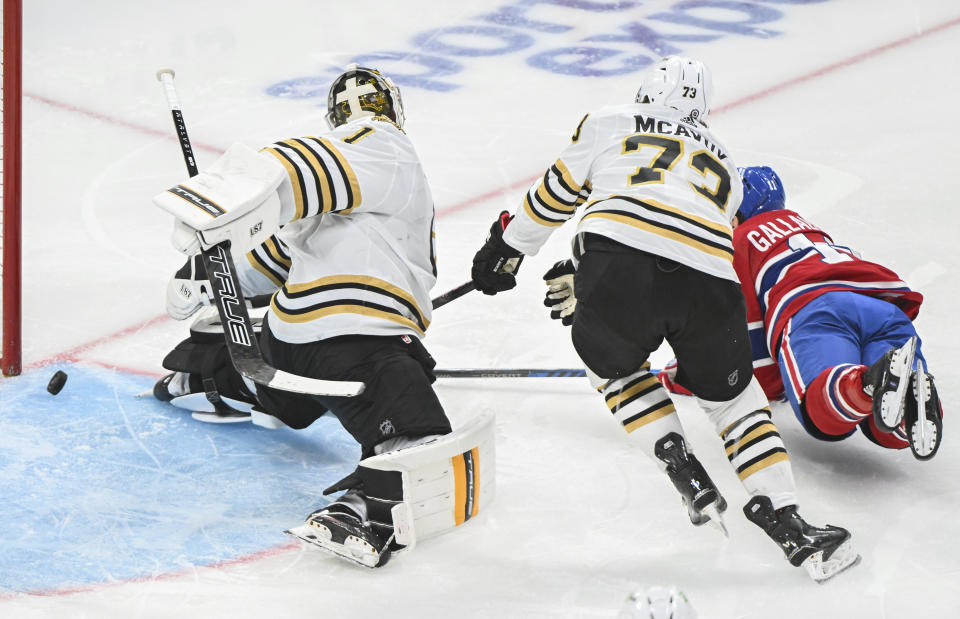 Montreal Canadiens' Brendan Gallagher (11) scores against Boston Bruins goaltender Jeremy Swayman as Bruins' Charlie McAvoy (73) defends during third-period NHL hockey game action in Montreal, Saturday, Nov. 11, 2023. (Graham Hughes/The Canadian Press via AP)