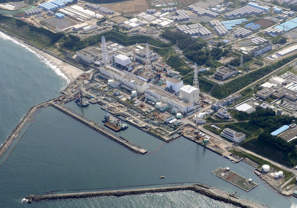 FILE - In this aerial file photo taken on Aug. 31, 2013, shows the Fukushima Dai-ichi nuclear plant at Okuma town in Fukushima prefecture, northeastern Japan. Experts said Friday they are skeptical about a plan to build a costly underground frozen wall at Japan’s crippled nuclear plant, a development that could delay construction plans. The experts and Japanese nuclear regulatory officials said during a meeting Friday, May 2, 2014 they weren’t convinced the project can resolve the contaminated water problem at the plant, which suffered meltdowns following the 2011 earthquake and tsunami. (AP Photo/Kyodo News, File) JAPAN OUT, MANDATORY CREDIT