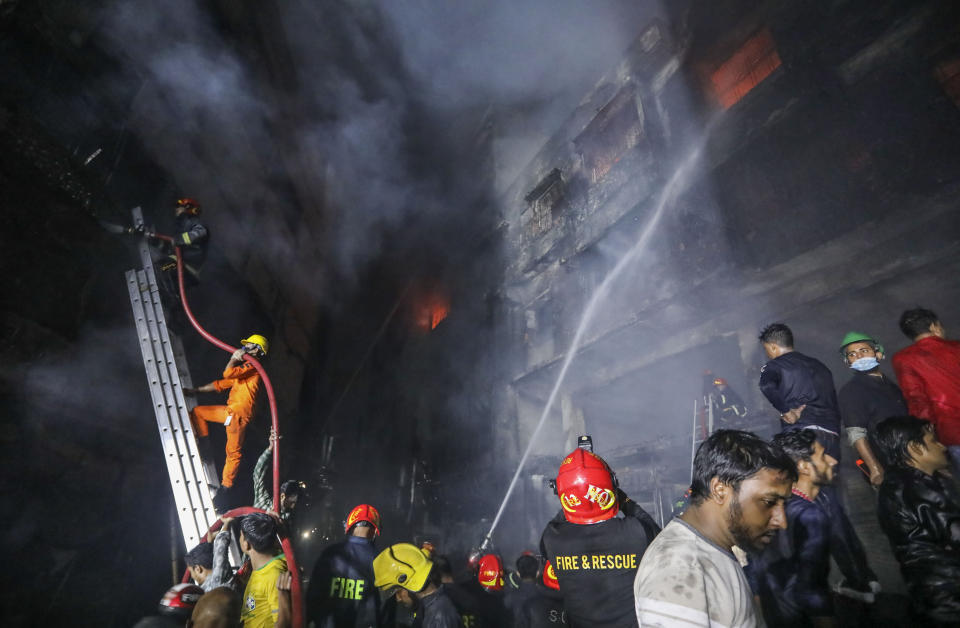 Firefighters work to douse flames in Dhaka, Bangladesh, Thursday, Feb. 21, 2019. A devastating fire raced through at least five buildings in an old part of Bangladesh's capital and killed scores of people. (AP Photo/Zabed Hasnain Chowdhury)