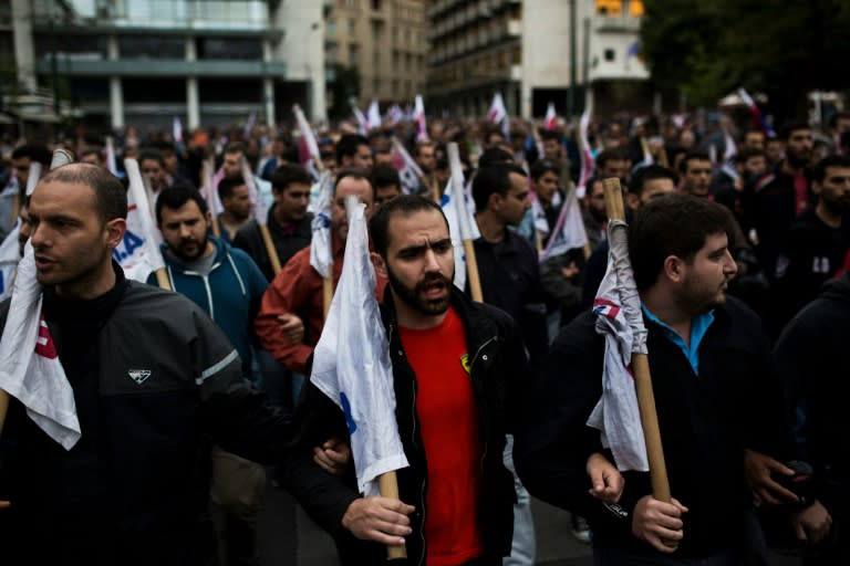 People demonstrate against a new package of tax hikes and fresh cuts in front of the Greek Parliament in Athens