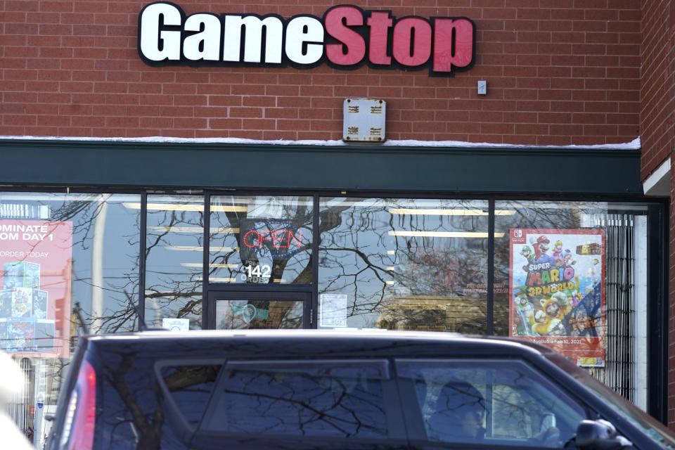 A vehicle passes in front of a GameStop store in Vernon Hills, Ill., Thursday, Jan. 28, 2021. The online trading platform Robinhood is moving to restrict trading in GameStop and other stocks that have soared recently due to rabid buying by smaller investors. GameStop stock has rocketed from below $20 earlier this month to close around $350 Wednesday as a volunteer army of investors on social media challenged big institutions who had placed market bets that the stock would fall. (AP Photo/Nam Y. Huh)