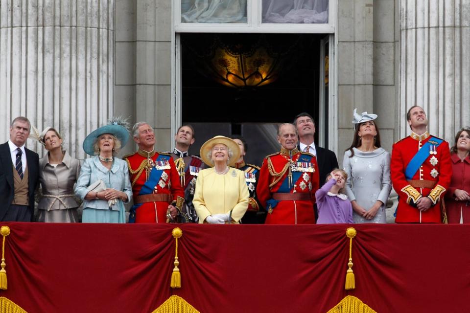 The Queen and her late husband Prince Philip watch a Royal Air Force fly pass with their family from the balcony of Buckingham Palace after the Trooping The Colour in 2012 (AP)