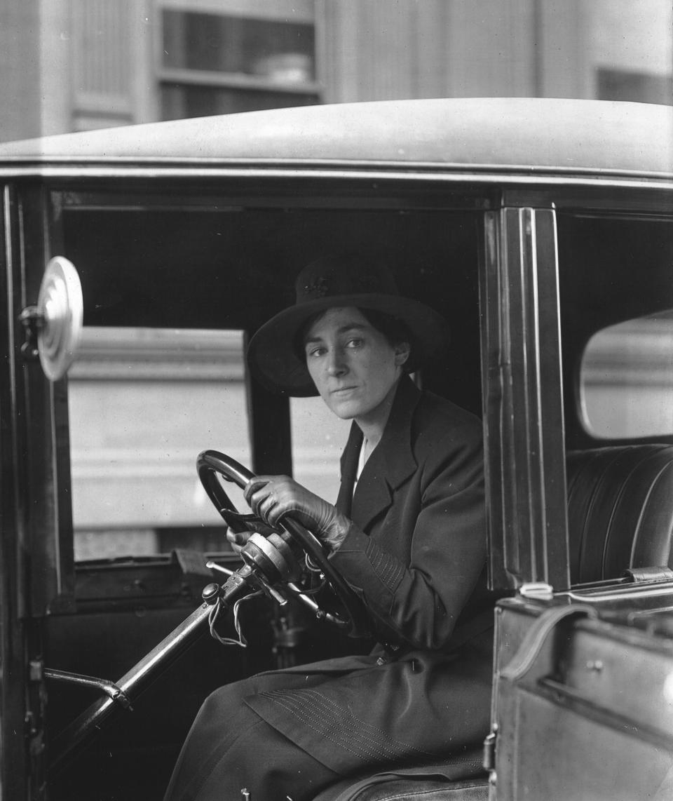 View of Philadelphia society matron, Mrs JL Ackerson, as she sits behind the wheel of an automobile, while acting as a chauffer for Fleet Hospital during the 1918 Spanish Flu epidemic, 1918. (Photo by PhotoQuest/Getty Images)