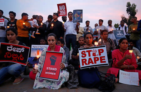 FILE PHOTO: People participate in a candle light vigil as they protest against the rape of an eight-year-old girl in Kathua near Jammu, and a teenager in Unnao, Uttar Pradesh state, in Bengaluru, India, April 13, 2018. REUTERS/Abhishek N. Chinnappa