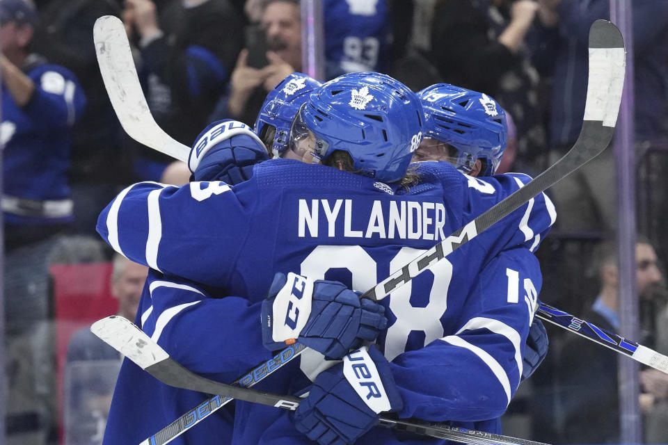 Toronto Maple Leafs celebrate after center Calle Jarnkrok (19) scored the winning overtime goal against the Tampa Bay Lightning in an NHL hockey game in Toronto, Monday, Nov. 6, 2023. (Chris Young/The Canadian Press via AP)