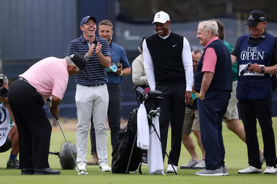 Golf legend Lee Trevino of the United States, left, prepares to play the ball watched by Northern Ireland's Rory McIlroy, Tiger Woods of the US and Jack Nicklaus, from left, during a 'Champions round' as preparations continue for the British Open golf championship on the Old Course at St. Andrews, Scotland, Monday July 11, 2022. The Open Championship returns to the home of golf on July 14-17, 2022, to celebrate the 150th edition of the sport's oldest championship, which dates to 1860 and was first played at St. Andrews in 1873. (AP Photo/Peter Morrison)