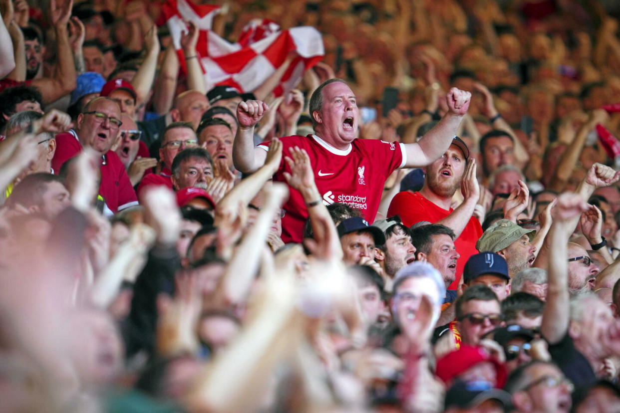 Des supporteurs des Reds de Liverpool en tribune.  - Credit:Jon Super/AP/Sipa