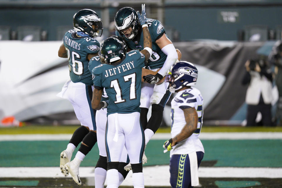 Philadelphia Eagles' Dallas Goedert (88) celebrates with Alshon Jeffery (17) and Miles Sanders (26) after scoring a touchdown during the first half of an NFL football game against the Seattle Seahawks, Monday, Nov. 30, 2020, in Philadelphia. (AP Photo/Chris Szagola)