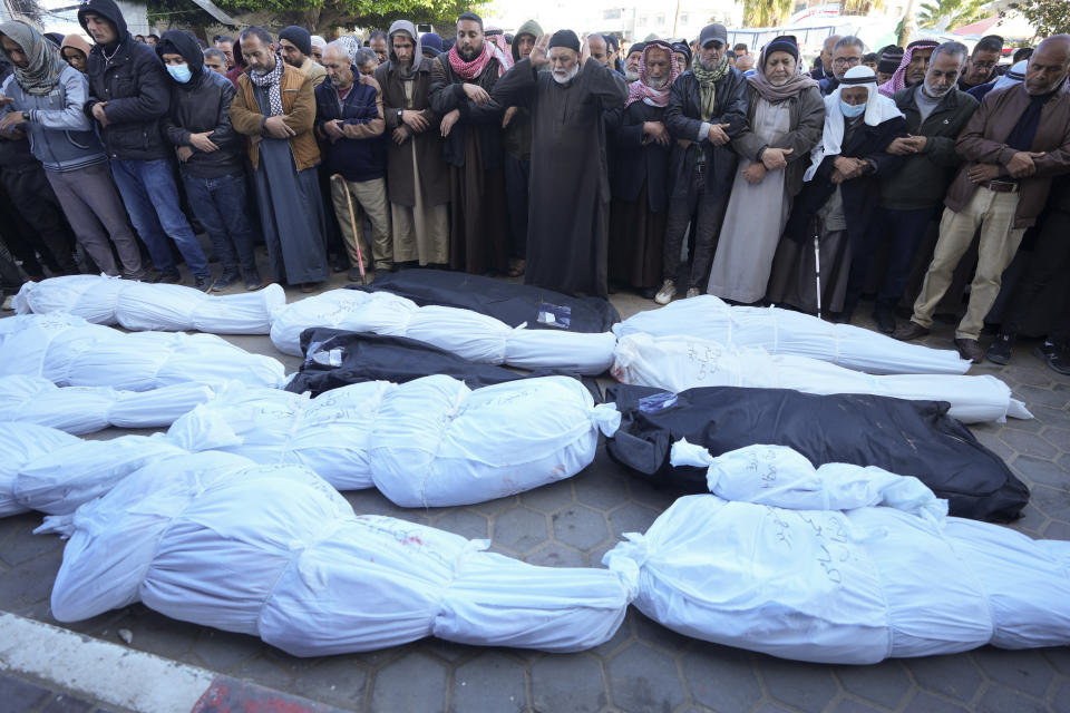 Palestinians mourn over relatives killed in the Israeli bombardments of the Gaza Strip at Al Aqsa Hospital in Deir al Balah on Wednesday, Feb. 21, 2024. (AP Photo/Adel Hana)