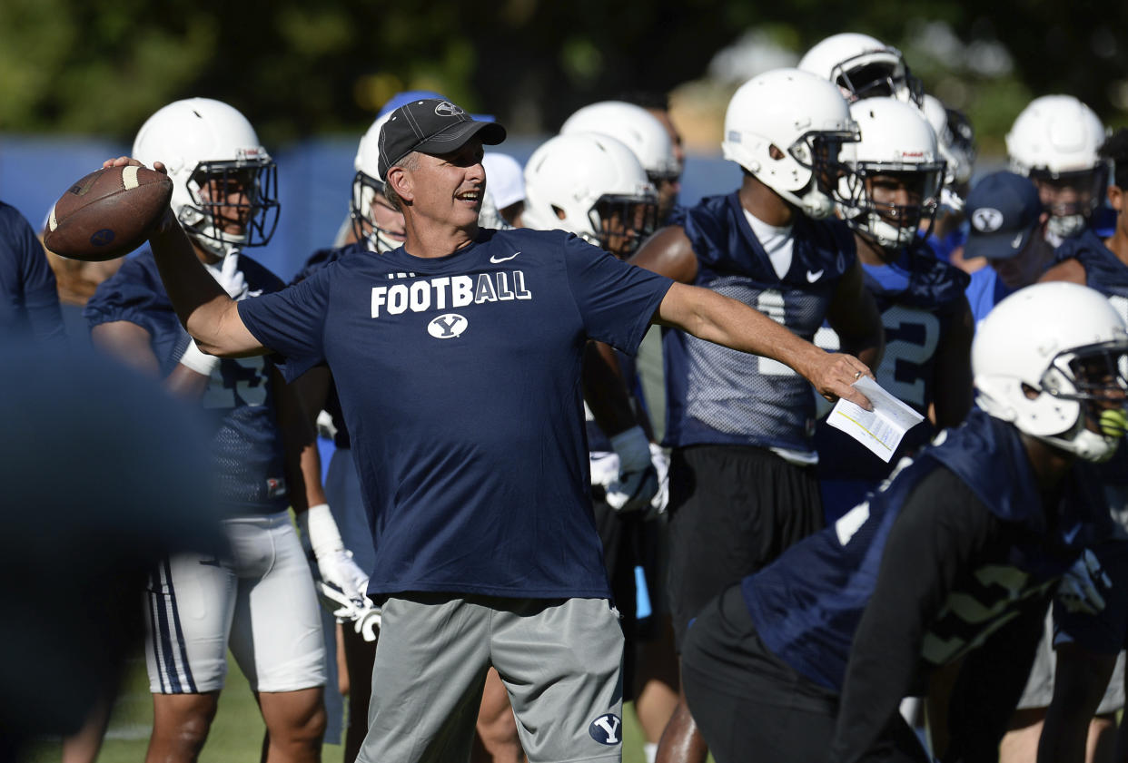 BYU football offensive coordinator and quarterbacks coach Ty Detmer works with the team during NCAA college football practice Thursday, July 27, 2017, in Provo, Utah. (Francisco Kjolseth/The Salt Lake Tribune via AP)