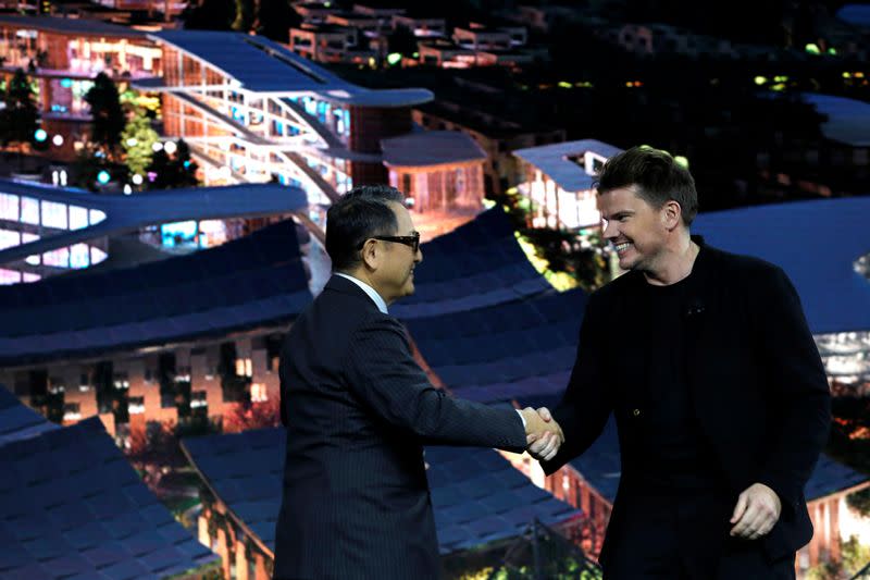 Akio Toyoda, president of Toyota Motor Corporation, greets Danish architect Bjarke Ingels, CEO of Bjarke Ingels Group during the 2020 CES in Las Vegas