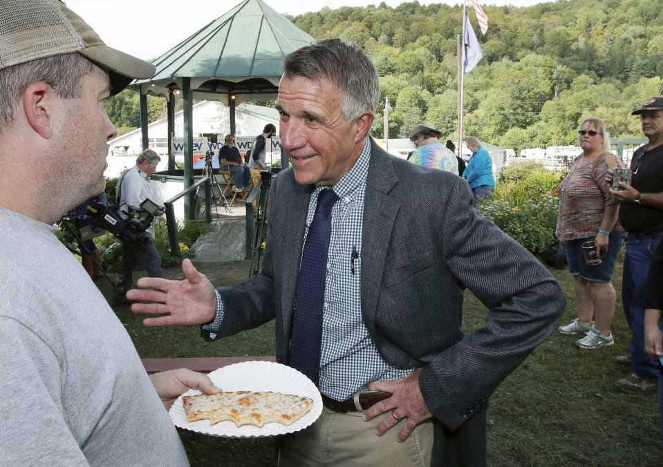 FILE - In this Sept. 14, 2018, file photo, Vermont Republican incumbent Gov. Phil Scott, right, talks with a fair-goer following a debate with Democratic challenger Christine Hallquist, at the Tunbridge World's Fair in Tunbridge, Vt. Hallquist is challenging Scott in the November general election (AP Photo/Charles Krupa, File)