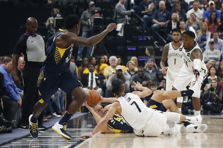 Oct 18, 2017; Indianapolis, IN, USA; Indiana Pacers forward Bojan Bogdanovic (44) attempts to pass on the ground against Brooklyn Nets forward Ronae Hollis-Jefferson (24) and guard Jeremy Lin (7) at Bankers Life Fieldhouse. Mandatory Credit: Brian Spurlock-USA TODAY Sports