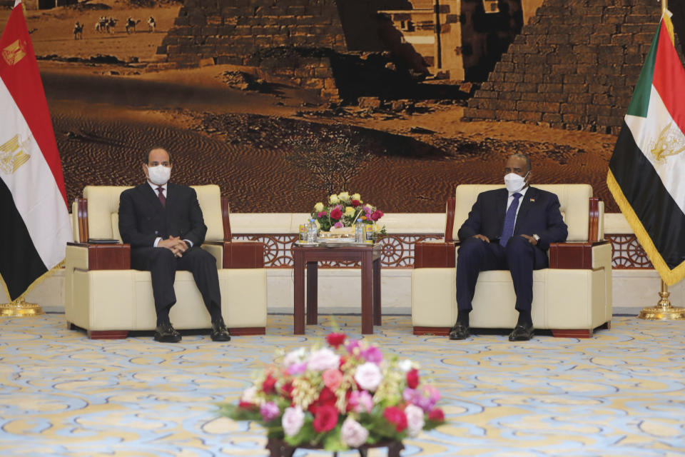 Egyptian President Abdel Fattah al-Sisi meets Chairman of the Sovereignty Council of Sudan Gen. Abdel Fattah Abdelrahman al-Burhan at the Presidential Palace in Khartoum, Sudan, Saturday, March. 6, 2021. Egypt's presidency says President Abdel Fattah el-Sissi trip was to address an array of issues, including economic and military ties and the two nations’ dispute with Ethiopia over a massive dam Addis Ababa is building on the Blue Nile. The visit comes amid a rapprochement between the two governments. (Presidency of Sudan via AP)