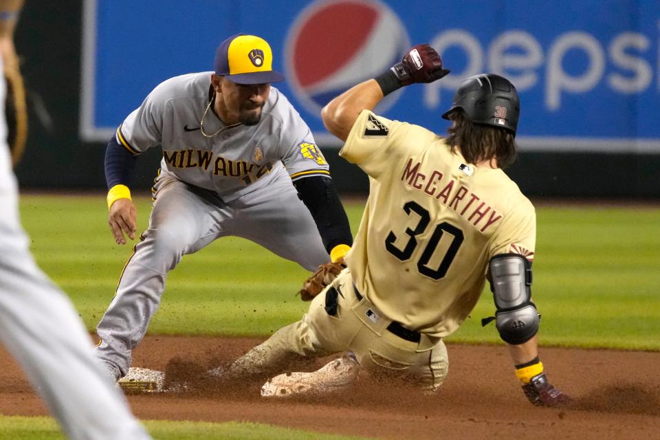 Sept. 2, 2022; Phoenix, Arizona, USA; Milwaukee Brewers third baseman Jace Peterson (14) tags out Arizona Diamondbacks left fielder Jake McCarthy (30) in the seventh inning at Chase Field.