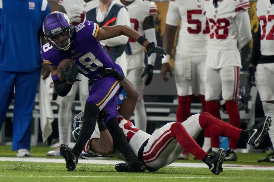 New York Giants' Adoree' Jackson stops Minnesota Vikings' Justin Jefferson after a catch during the second half of an NFL wild card football game Sunday, Jan. 15, 2023, in Minneapolis. (AP Photo/Charlie Neibergall)