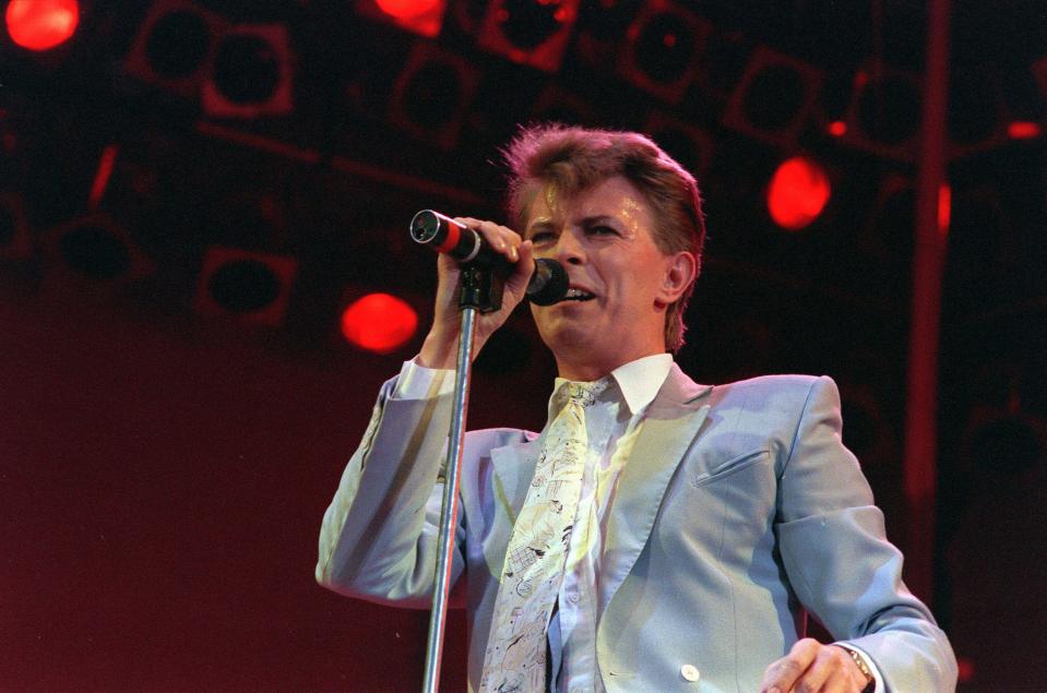 Rock star David Bowie performs on stage at Wembley Stadium, London, July 13, 1985, during the Live Aid famine relief rock concert. (AP Photo/Joe Schaber)