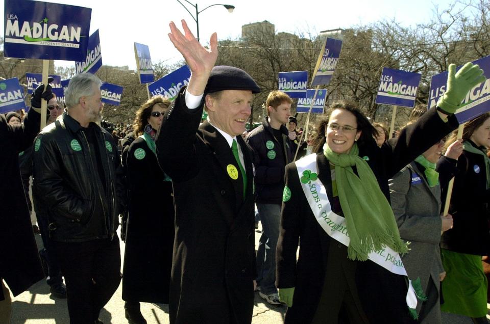 FILE - In this March 16, 2002 file photo, Illinois Democratic Attorney General candidate Lisa Madigan, right, walks in the St. Patrick's Day parade with her father, then Illinois House Speaker Michael Madigan, left, in Chicago. State Rep. Madigan, a Chicago Democrat who virtually set Illinois' political agenda as House speaker before he was ousted last month, announced Thursday, Feb. 18, 2021, that he is resigning his seat in the Legislature. (AP Photo/Stephen J. Carrera File)