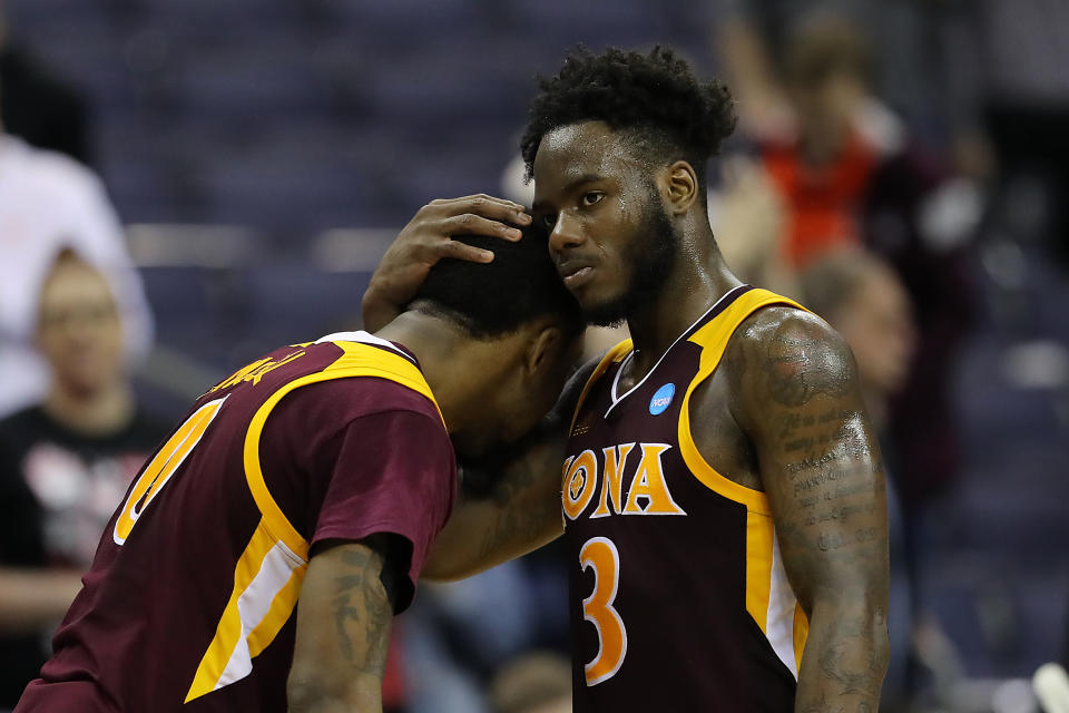 <p>Asante Gist #3 of the Iona Gaels embraces teammate Rickey McGill #0 after their 73-88 loss to the North Carolina Tar Heels in the first round of the 2019 NCAA Men’s Basketball Tournament at Nationwide Arena on March 22, 2019 in Columbus, Ohio. </p>