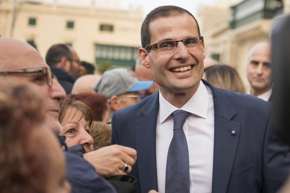 The new Prime Minister of Malta Robert Abela salutes the crowd as he walks out of the Presidential palace in Valletta, Malta, after the swear-in ceremony, Monday, Jan. 13, 2020. Abela is replacing Joseph Muscat after weeks of protests demanding accountability in the investigation of the car bomb slaying of an anti-corruption journalist who targeted his government. (AP Photo/Rene' Rossignaud)