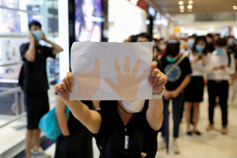 Protest to mark the first anniversary of an attack in a train station by an armed crowd wearing white shirts, demanding justice for the victims of violence and broader freedoms, at a shopping mall in Hong Kong's Yuen Long