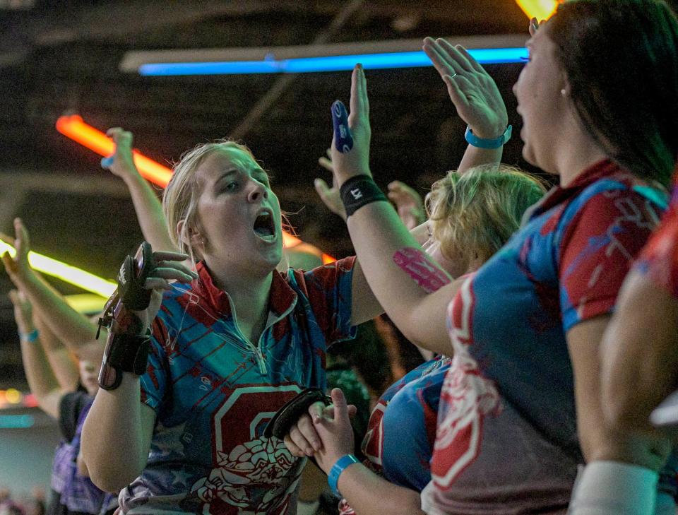 Stacey Spaulding celebrates with Seabreeze teammates during the state bowling championships at Boardwalk Bowl Entertainment Center in Orlando on Thursday, Nov. 2, 2023.