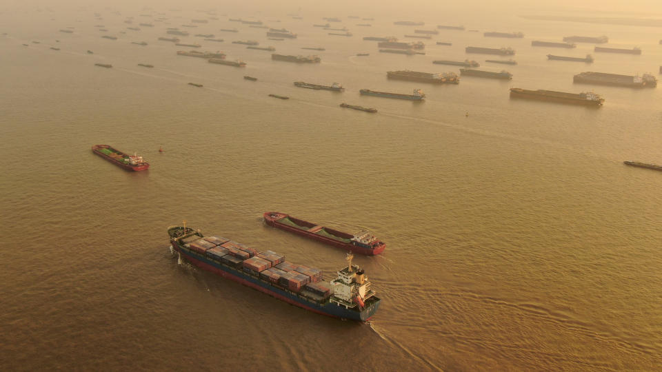 A cargo ship sails along the Yangtze River as seen from an aerial photo in Nantong in eastern China's Jiangsu Province, Jan. 2, 2021. China's exports rose in 2020 despite pressure from the coronavirus pandemic and a tariff war with Washington, boosting its politically volatile trade surplus to $535 billion, one of the highest ever reported. (Chinatopix via AP)