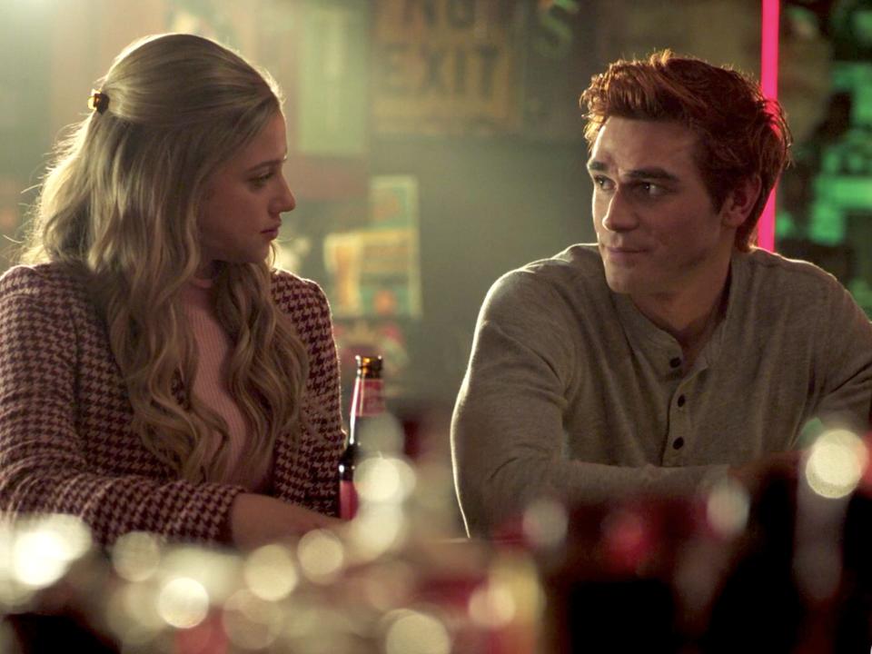 Betty and Archie sitting at a bar and looking at each other on the season five finale of "Riverdale."