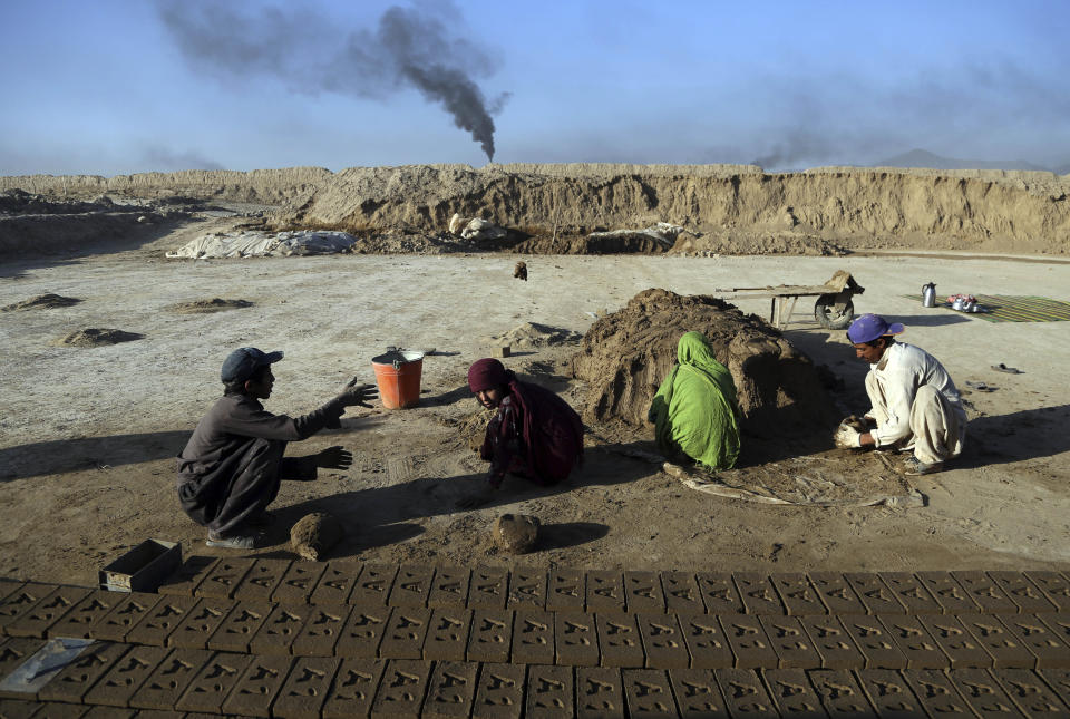 In this Wednesday, June 19, 2019, photo, Atiqullah, 30, right, and his son Kamran, 10, left, work at a brick factory on the outskirts of of Kabul, Afghanistan. “My children wake up early in the morning and right after prayers they come here for work, so they don’t have time for school,” said Atiqullah, who like many Afghans has only one name. “These days if you don’t work, you cannot survive.”(AP Photo/Rahmat Gul)