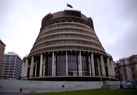 A pedestrian walks past the New Zealand parliament building known as the Beehive in central Wellington, New Zealand