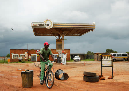 A man cycles past a petrol station closed after protests in Harare, Zimbabwe, January 15, 2019. REUTERS/Philimon Bulawayo