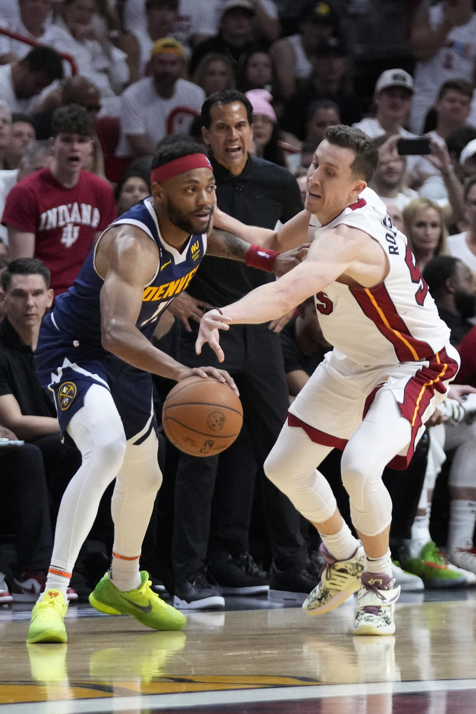 Denver Nuggets forward Bruce Brown (11) steals the ball from Miami Heat forward Duncan Robinson (55) during the second half of Game 4 of the basketball NBA Finals, Friday, June 9, 2023, in Miami. (AP Photo/Wilfredo Lee)