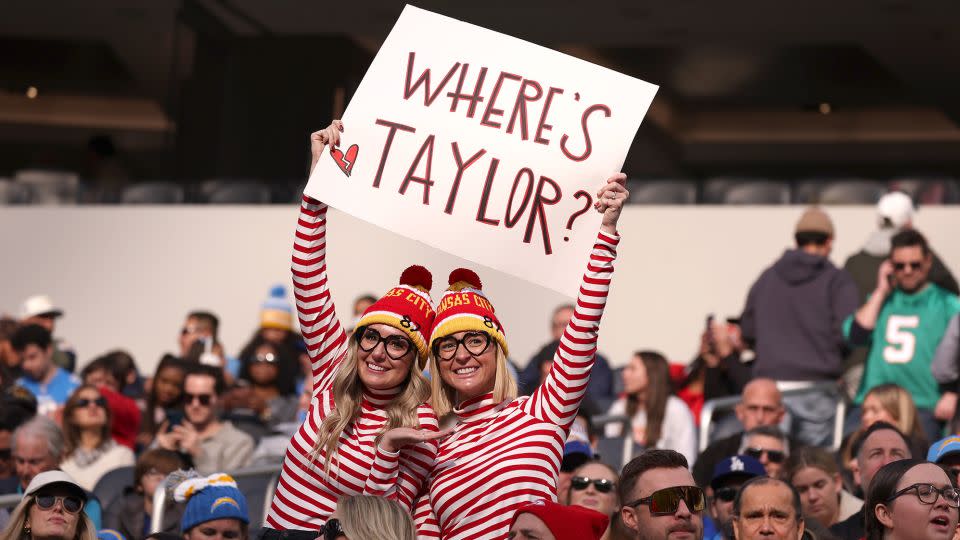 Fans at a Kansas City Chiefs game ponder the question that nearly every NFL broadcaster has asked at one point during the 2023-2024 season: "WHERE'S TAYLOR?" - Harry How/Getty Images