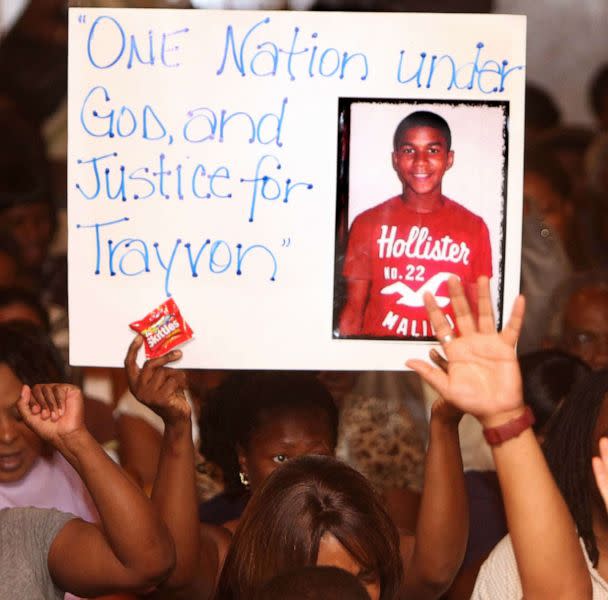 PHOTO: In this March 20, 2012, file photo, a protester holds a sign inside the Allen Chapel AME Church in Sanford, Fla. A meeting hosted by the NAACP was held to address community concerns after the shooting of Trayvon Martin. (Orlando Sentinel/TNS via Getty Images, FILE)