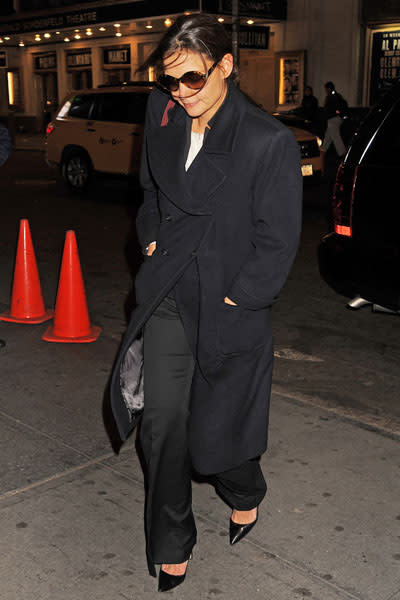 Katie Holmes: Katie Holmes is prepared for the cold New York City weather all bundled up in a long trench pea coat, wide-legged trousers, chic heels and a white top. In typical Hollywood style, she sports sunnies even at night. Picture by: Demis Maryannakis / Splash News