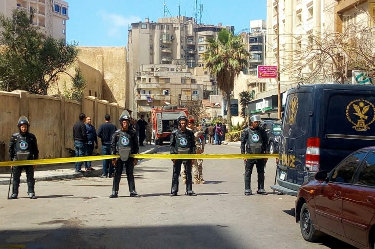 Egyptian riot police cordon off the street at the site of a bomb attack in the northern city of Alexandria, which hit a convoy of the city's security chief, on March 24, 2018