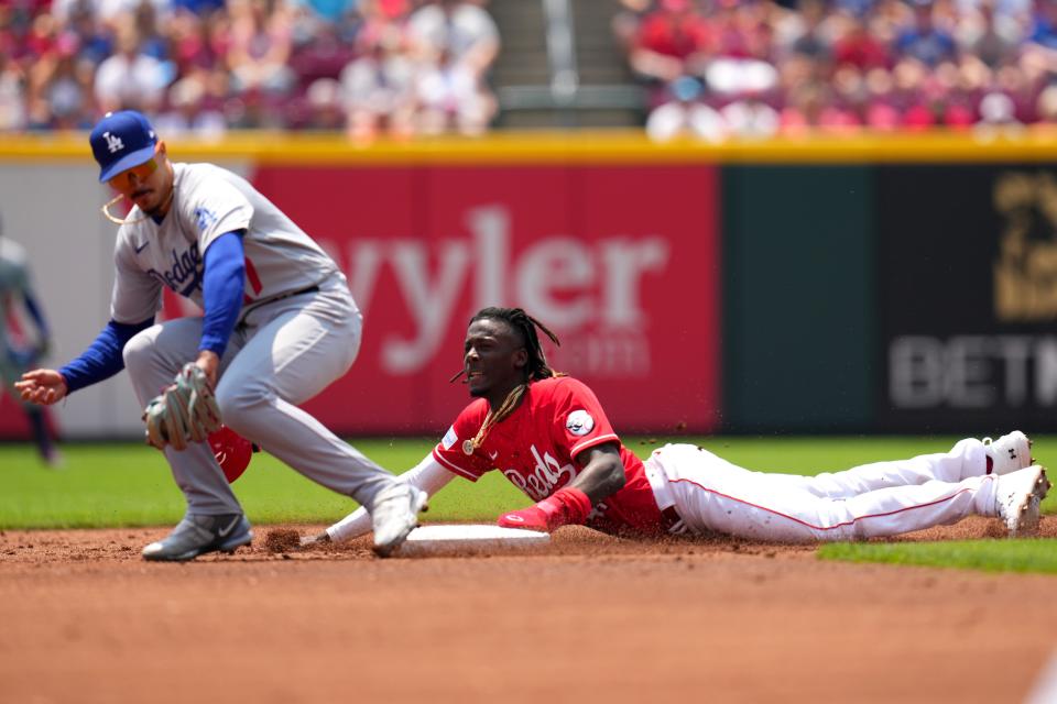 Cincinnati Reds shortstop Elly De La Cruz starts his slide very early, which gives him the ability to fly into the base.