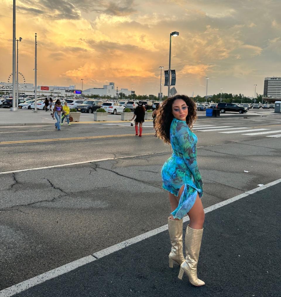 Geselle Valera outside the Beyoncé concert on July 29 wearing a blue mini dress with knee-high boots.