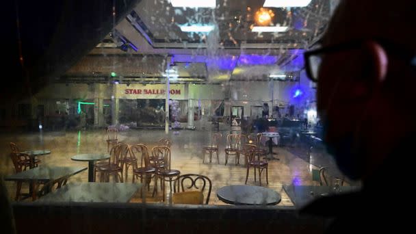PHOTO: A man takes a closer look through the glass at the interior of The Star Dance Studio in Monterey Park, Calif., Jan. 23, 2023. (Frederic J. Brown/AFP via Getty Images)