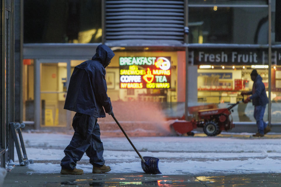 Workers remove snow from the plaza at 2 Penn Center in Center City Philadelphia, Tuesday morning Jan. 16, 2024. (Alejandro A. Alvarez/The Philadelphia Inquirer via AP)