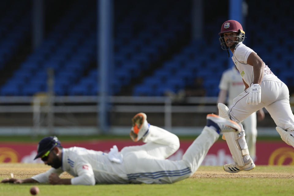 West Indies' Tagenarine Chanderpaul runs after playing a shot as India's Ajinkya Rahane fields on day four of their second cricket Test match at Queen's Park in Port of Spain, Trinidad and Tobago, Sunday, July 23, 2023. (AP Photo/Ricardo Mazalan)