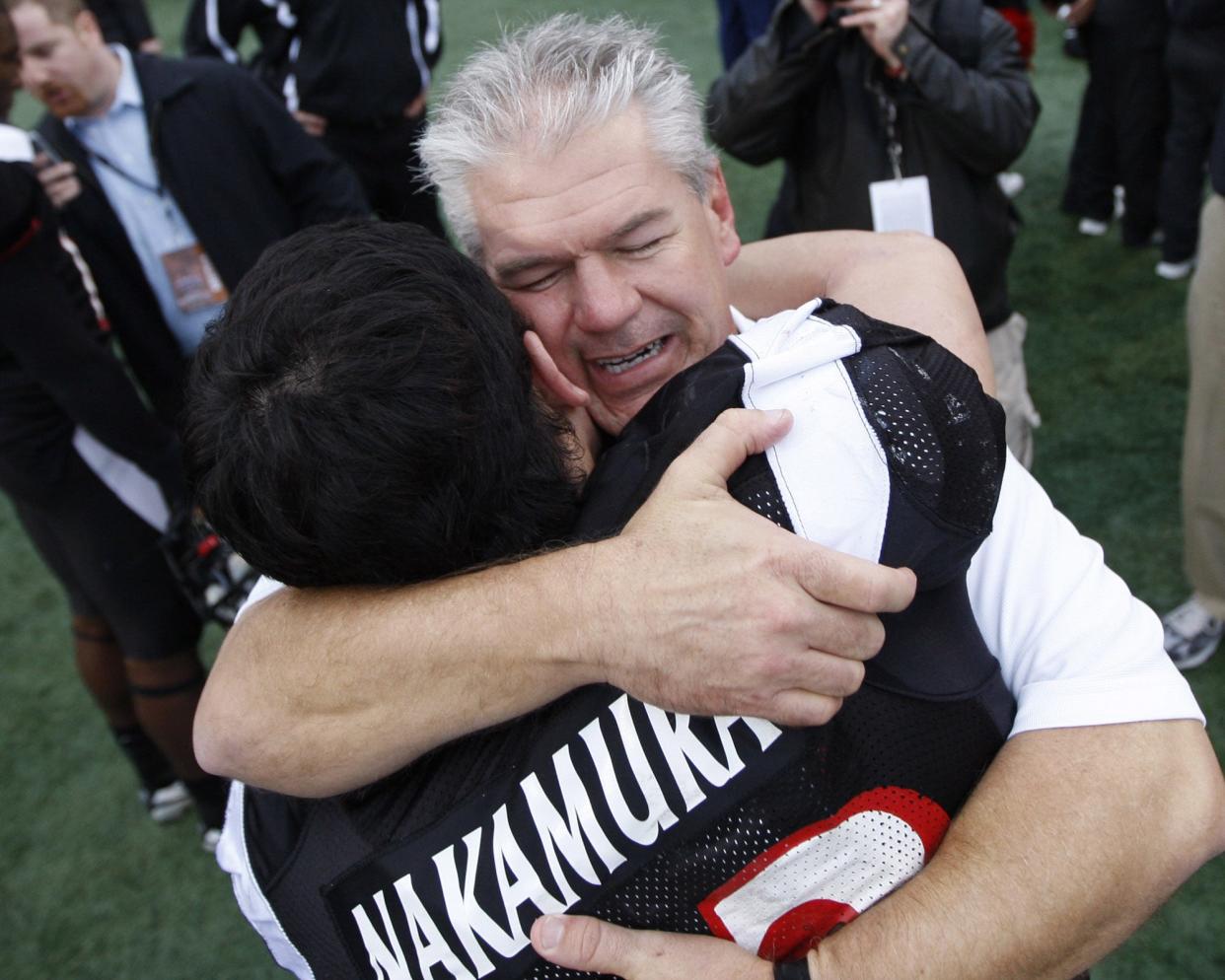 University of Cincinnati defensive backs coach Kerry Coombs celebrates with defensive back Haruki Nakamura after their 31-21 win against Southern Mississippi in the PapaJohns.com Bowl in Birmingham, Alabama Saturday December 22, 2007.