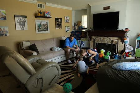Danny and Bekah Bowman enjoy their 4-year old son Ely at their family home in Irvine, California, U.S.August 30, 2017. REUTERS/Mike Blake/Files