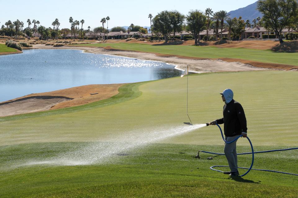 Marcos Garcia waters the grass near the 18th green of the Nicklaus Tournament Course at PGA West ahead of the American Express PGA tournament which starts next week in La Quinta, Calif., Jan. 9, 2024.